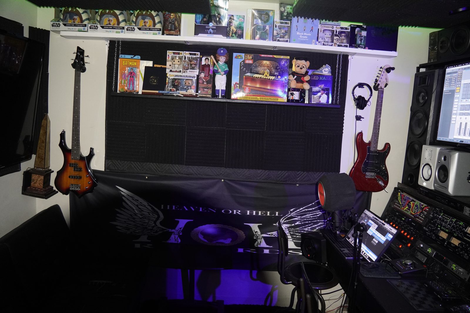 Guitar wall under purple lighting